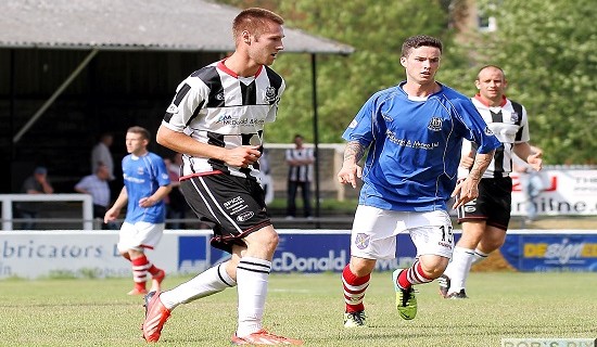 FEATURED IMAGEBrian Cameron slips a pass forward as trialist William Robertson closes in  wtm